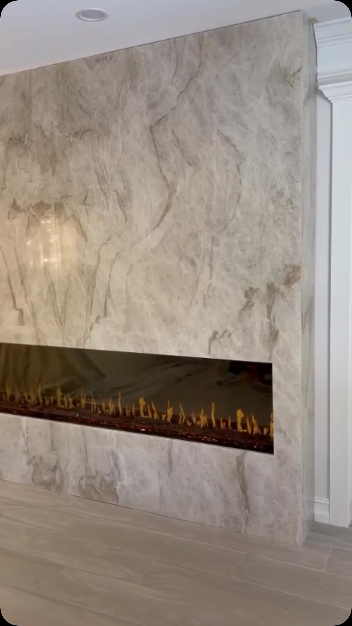 Fireplace surround in stone with fire